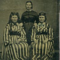 Tintype of two unidentified girls with their mother (?)